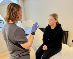 With a client describing the process of subtle and natural beauty enhancements. The transformation showcases refreshed, rejuvenated skin or facial features after expert treatment.